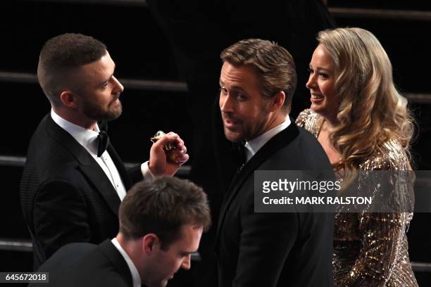Singer Justin Timberlake shakes hands with nominee for Best Actor in "La La Land" Ryan Gosling as he arrives at the 89th Oscars on February 26, 2017...