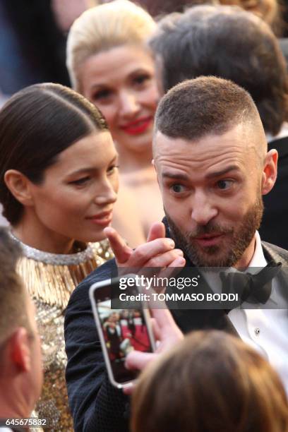 Nominee for Best Music "Can't Stop The Feeling" for Trolls Justin Timberlake gestures as he arrives with his wife US actress Jessica Biel on the red...