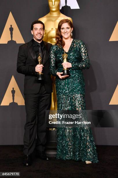 Director Ezra Edelman and producer Caroline Waterlow, winners of Best Documentary Feature for 'O.J.: Made in America' pose in the press room during...