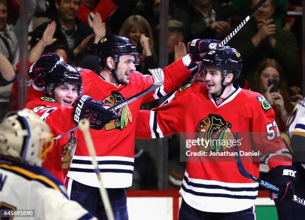 Patrick Kane, Artem Anisimov and Trevor van Riemsdyk of the Chicago Blackhawks celebrate Anisimovs' third period goal against the St. Louis Blues at...