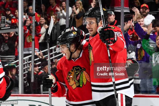 Patrick Kane and Artem Anisimov of the Chicago Blackhawks celebrate after Anisimov scored the game-winning goal in the third period against the St....