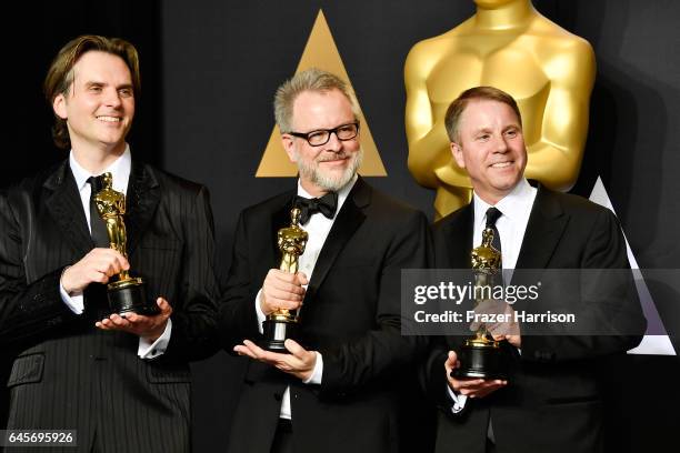 Co-directors Byron Howard and Rich Moore and producer Clark Spencer, winners of the Best Animated Feature Film award for 'Zootopia' pose in the press...