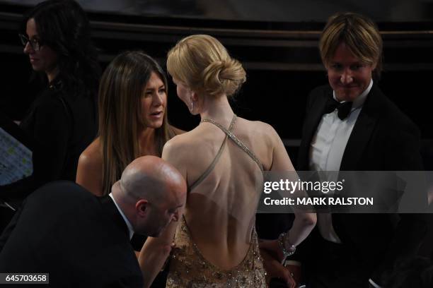 Actress Jennifer Aniston speaks with nominee for Best Supporting Actress in "Lion" Nicole Kidman next to Australian singer Keith Urban at the 89th...