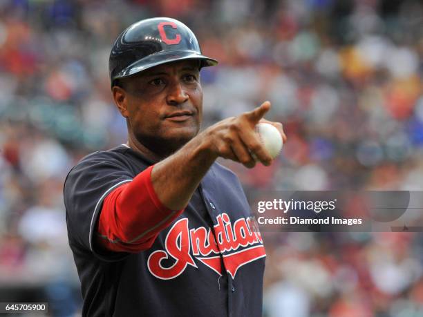 First base coach Sandy Alomar Jr. #15 of the Cleveland Indians points toward the crowd as he walks onto the field during a game against the Los...