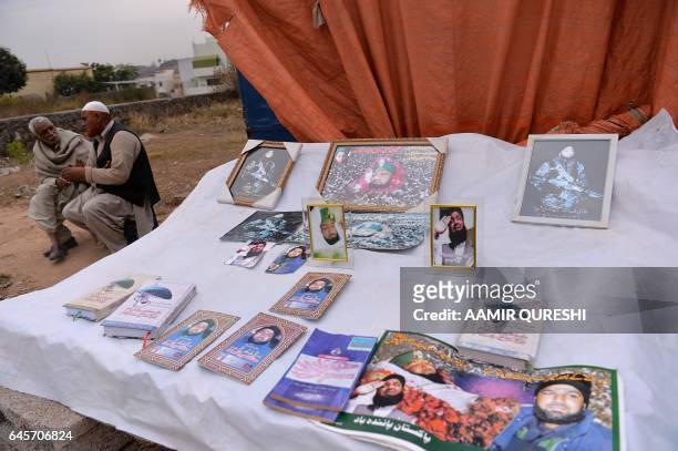 This photograph taken on February 15, 2017 shows books and posters on offer at the shrine of Mumtaz Qadri, was hanged last year for the murder of a...
