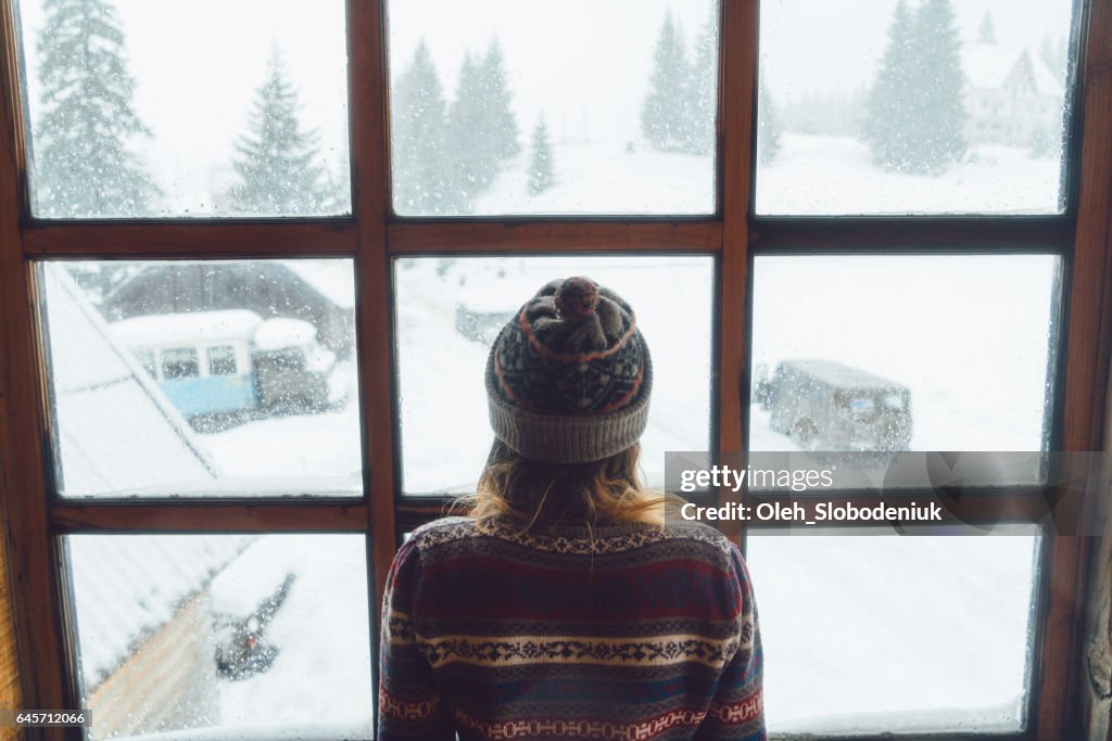 Woman looking in the window in winter