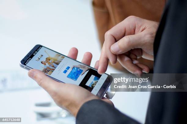 Visitor inspects the new LG G6 during the LG G6 launch during the Mobile World Congress, on February 26, 2017 in Barcelona, Spain.