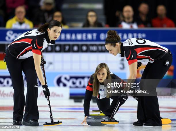 Rachel Homan of Ontario delivers a stone as Lisa Weagle and Joanne Courtney sweep in the Gold Medal match against Manitoba during the 2017 Scotties...