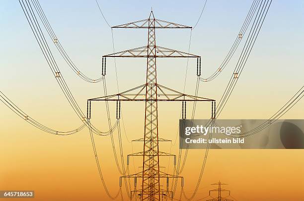 Hochspannungsmasten bei Sonnenuntergang in Hamburg, Deutschland, Europa