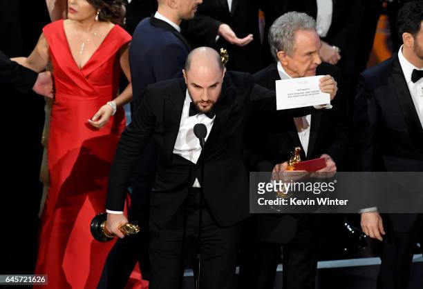 La La Land' producer Jordan Horowitz holds up the winner card reading actual Best Picture winner 'Moonlight' with actor Warren Beatty onstage during...
