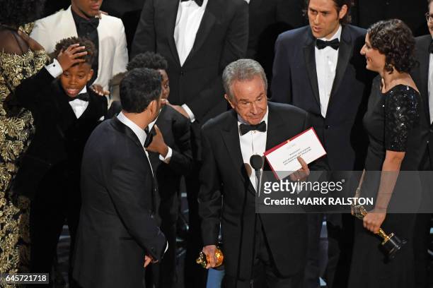 The cast of "Moonlight" and ""La La Land" appear on stage as presenter Warren Beatty shows the winner's envelope for Best Movie "Moonlight" on stage...