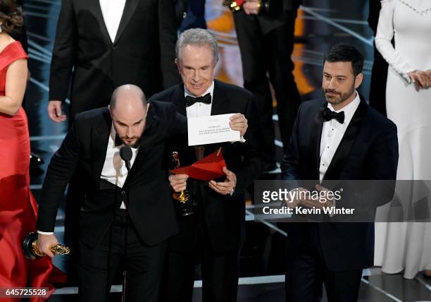 La La Land' producer Jordan Horowitz holds up the winner card reading actual Best Picture winner 'Moonlight' with actor Warren Beatty and host Jimmy...