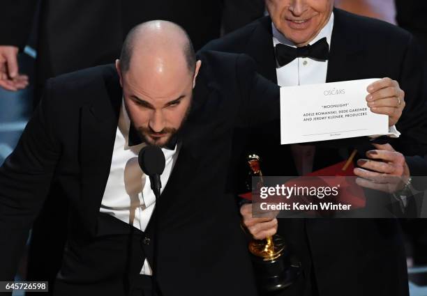 La La Land' producer Jordan Horowitz holds up the winner card reading actual Best Picture winner 'Moonlight' with actor Warren Beatty onstage during...