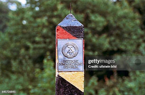 Innerdeutsche Zonengrenze zur DDR bei Helmstedt 1974. Grenzpfahl mit DDR Emblem; DDR-Grenzsäulen markieren den Verlauf der Staatsgrenze der DDR