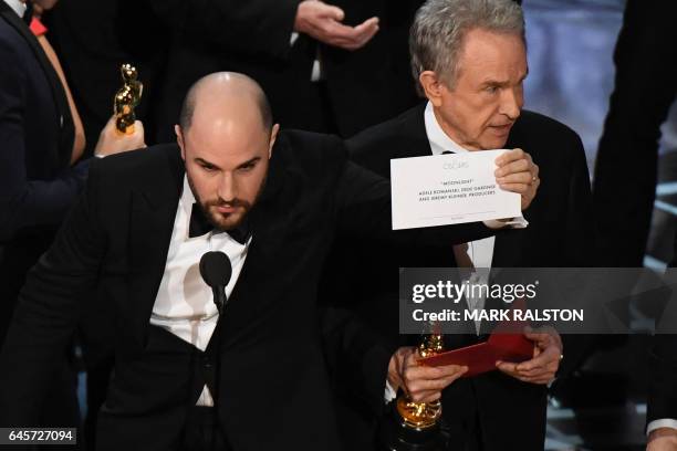 La La Land" producer Jordan Horowitz shows the card reading Best Film 'Moonlight" next to US actor Warren Beatty after the latter mistakingly read...