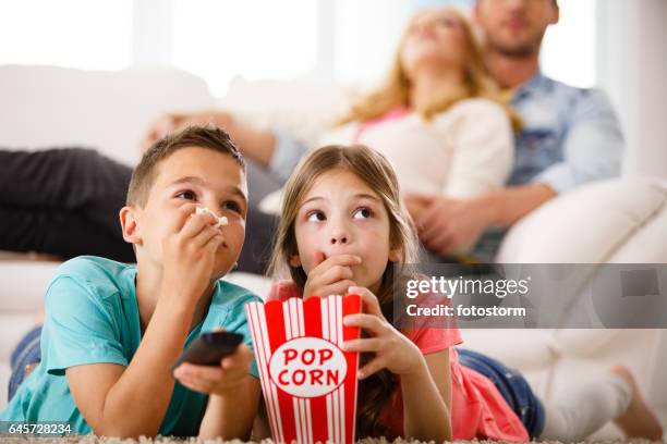 children watching tv, eating popcorn - boy watching tv stock pictures, royalty-free photos & images