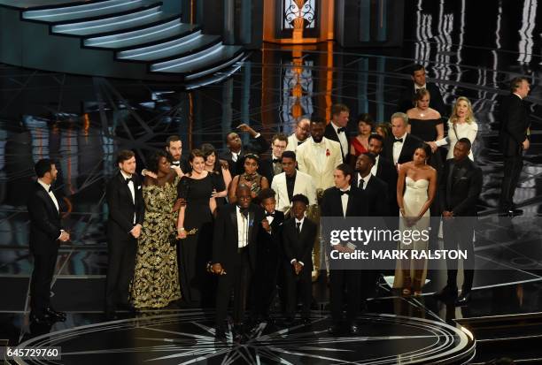 Director Barry Jenkins speaks after "Moonlight" won the Best Film award as Host Jimmy Kimmel looks on at the 89th Oscars on February 26, 2017 in...