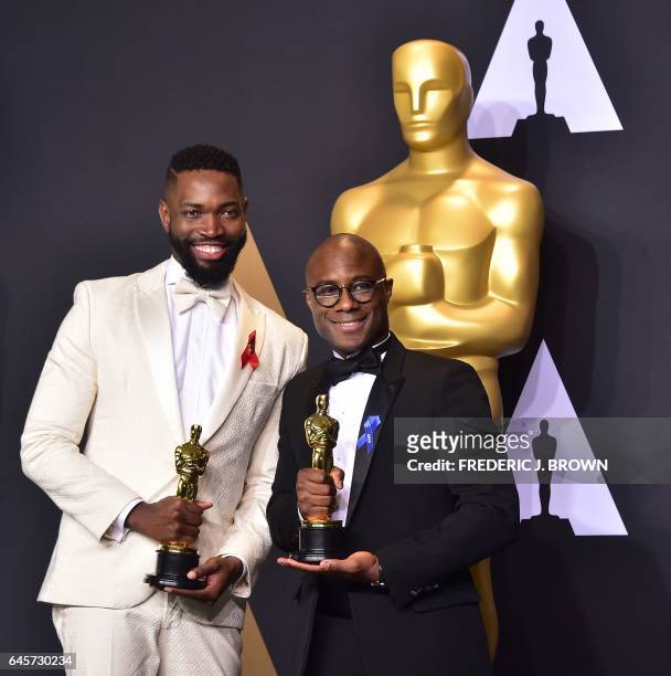 Writer/director Barry Jenkins and writer Tarell Alvin McCraney pose in the press room with the Best Adapted Screenplay award for 'Moonlight' during...