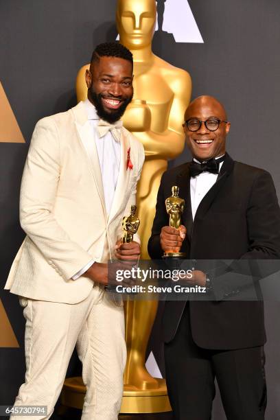 Screenwriter Tarell Alvin McCraney and filmmaker Barry Jenkins, winners of the award for Adapted Screenplay for 'Moonlight,' pose in the press room...