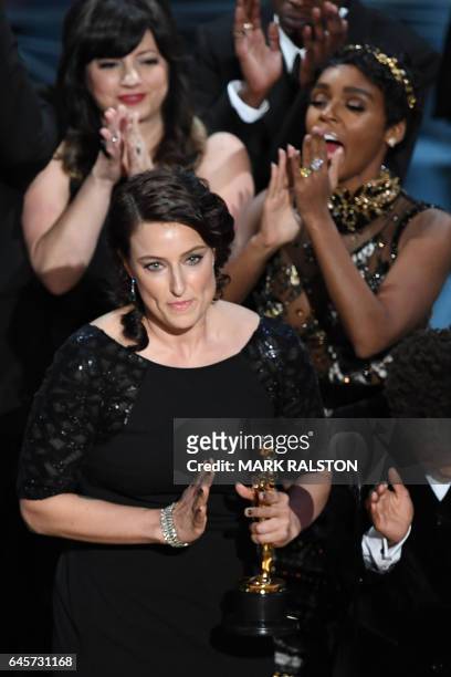 Producer Adele Romanski celebrates on stage after she won the Best Film award for "Moonlight" at the 89th Oscars on February 26, 2017 in Hollywood,...