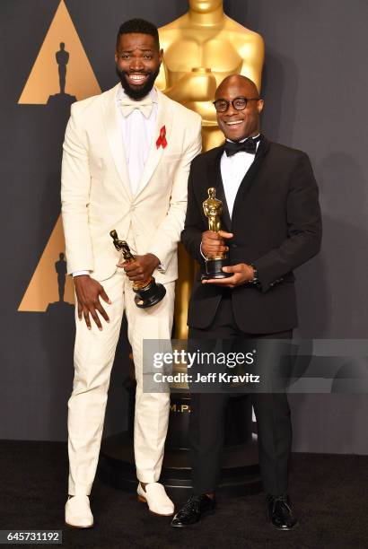 Writer/director Barry Jenkins and writer Tarell Alvin McCraney, winners of the Best Adapted Screenplay for 'Moonlight,' pose in the press room during...
