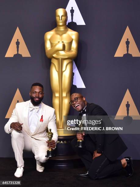 Writer/director Barry Jenkins and writer Tarell Alvin McCraney pose in the press room with the Best Adapted Screenplay award for 'Moonlight' during...