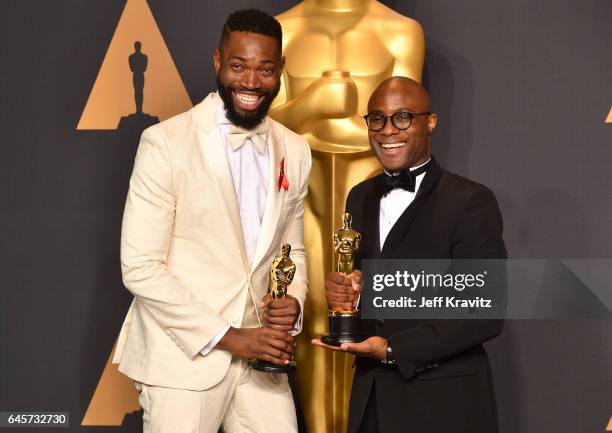 Writer/director Barry Jenkins and writer Tarell Alvin McCraney, winners of the Best Adapted Screenplay for 'Moonlight,' pose in the press room during...