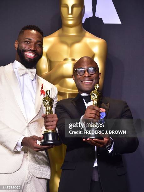 Writer/director Barry Jenkins and writer Tarell Alvin McCraney pose in the press room with the Best Adapted Screenplay award for 'Moonlight' during...