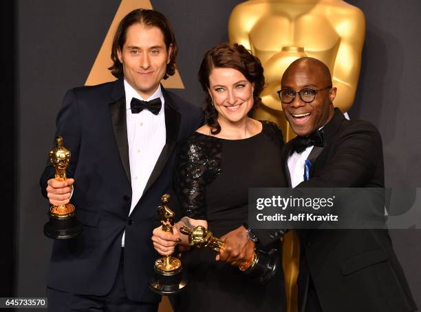 Producers Jeremy Kleiner, Adele Romanski, and director Barry Jenkins, winners of the Best Picture award for "Moonlight," pose in the press room...