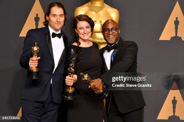Producers Jeremy Kleiner and Adele Romanski , winners of the award for Best Picture for 'Moonlight,' pose with filmmaker Barry Jenkins in the press...
