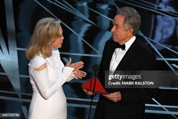 Actors Faye Dunaway and Warren Beatty present on stage the Best Film award at the 89th Oscars on February 26, 2017 in Hollywood, California. / AFP /...