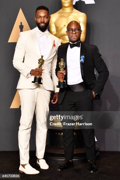 Screenwriter Tarell Alvin McCraney and writer/director Barry Jenkins, winners of Best Adapted Screenplay for 'Moonlight', pose in the press room...