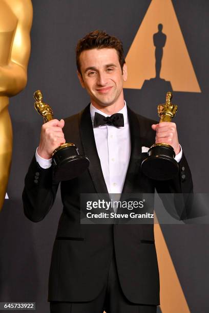 Composer Justin Hurwitz, winner of the awards for Music and Music for 'La La Land,' poses in the press room during the 89th Annual Academy Awards at...