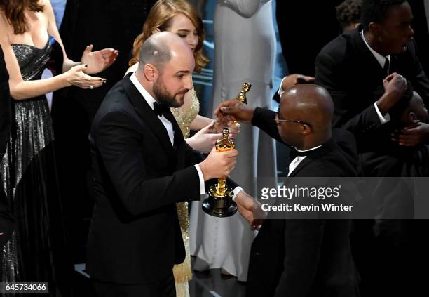 La La Land' producer Jordan Horowitz hands over the Best Picture award to 'Moonlight' writer/director Barry Jenkins following a presentation error...