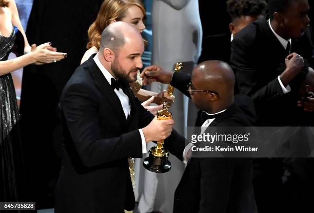 La La Land' producer Jordan Horowitz hands over the Best Picture award to 'Moonlight' writer/director Barry Jenkins following a presentation error...