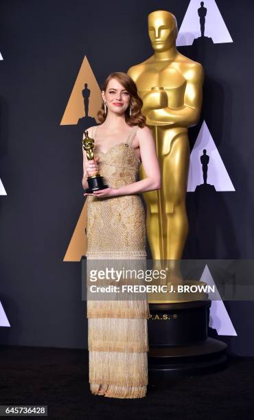Emma Stone poses in the press room with the Oscar for Best Actress during the 89th Annual Academy Awards on February 26 in Hollywood, California. /...