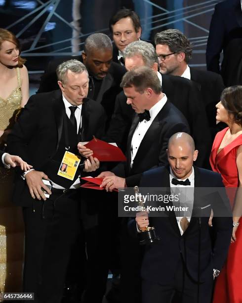 La La Land' producer Fred Berger speaks at the microphone as production staff and representatives from PricewaterhouseCoopers, Martha L. Ruiz and...