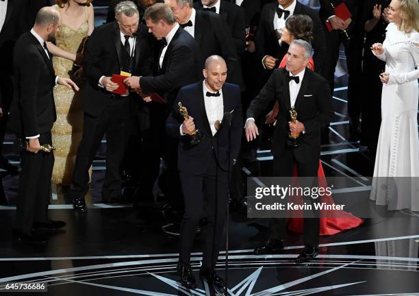 La La Land' producer Fred Berger speaks at the microphone with producer Marc Platt as production staff and representatives from...