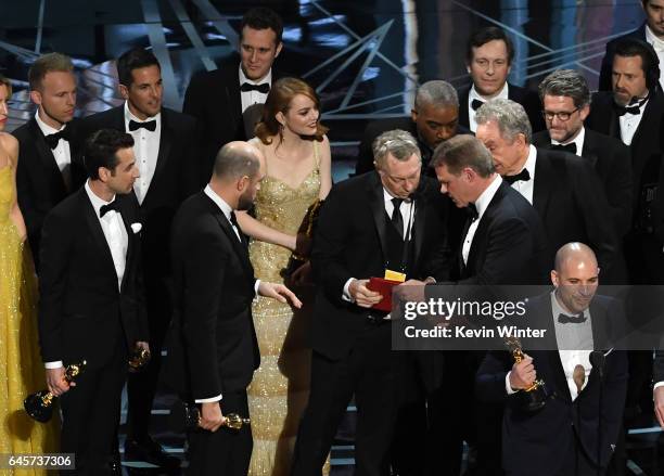 La La Land' producer Fred Berger speaks at the microphone as production staff consult behind him regarding a presentation error of the Best Picture...