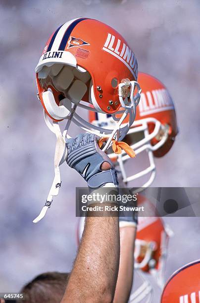 General view of the Illinois Fighting Illini team holding their helmets up during the game against the Pennsylvania State Nittany Lions at Beaver...