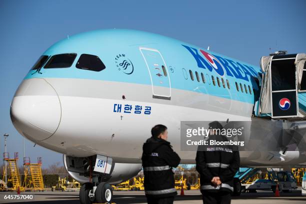 Employees stand in front of a Boeing Co. 787-9 Dreamliner passenger aircraft operated by Korean Air Lines Co. During a media preview at Incheon...