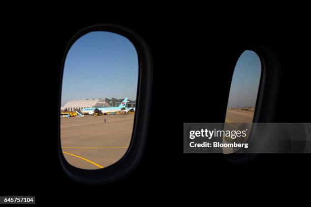 Korean Air Lines Co. Cargo planes are seen through the windows of the company's Boeing Co. 787-9 Dreamliner passenger aircraft during a media preview...