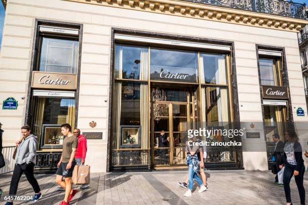 cartier store on avenue des champs-elysees and crowds of tourists, paris - champs elysees cartier stock pictures, royalty-free photos & images