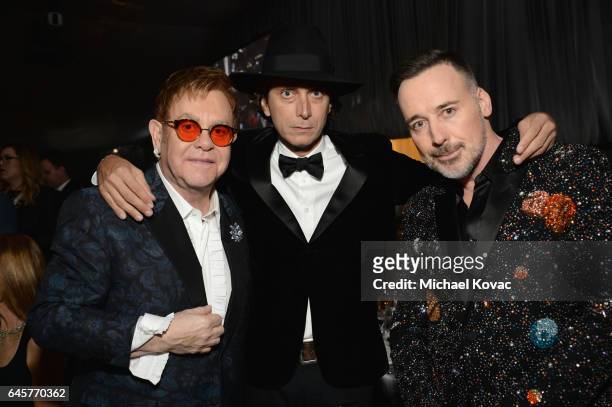 Host Sir Elton John, designer Hedi Slimane, and David Furnish attend the 25th Annual Elton John AIDS Foundation's Academy Awards Viewing Party at The...