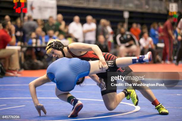 Euless Trinty Highschool junior Mack Beggs in black, a transgender wrestler competing in the girls state championship tournament, wrestles against...