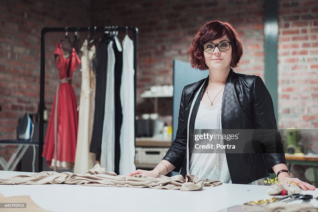 Portrait of confident designer in bridal shop
