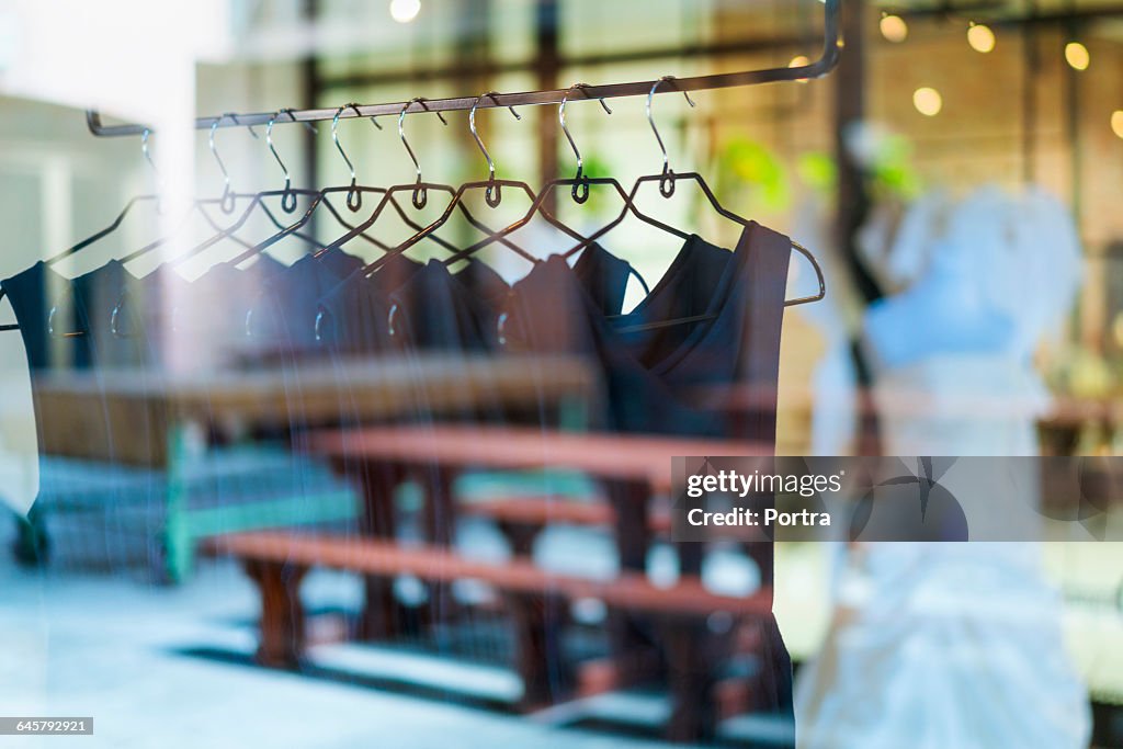 Black dresses arranged on clothes rack