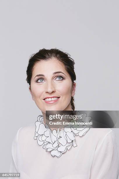 adult woman daydreaming happy with white top - rufo imagens e fotografias de stock