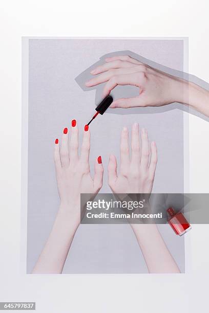 applying red nail varnish - red nail polish stockfoto's en -beelden