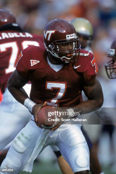 Michael Vick of the Virginia Tech Hokies sets to hand off the ball during the game against the Pittsburgh Panthers at Blacksburgh, Virginia. The...